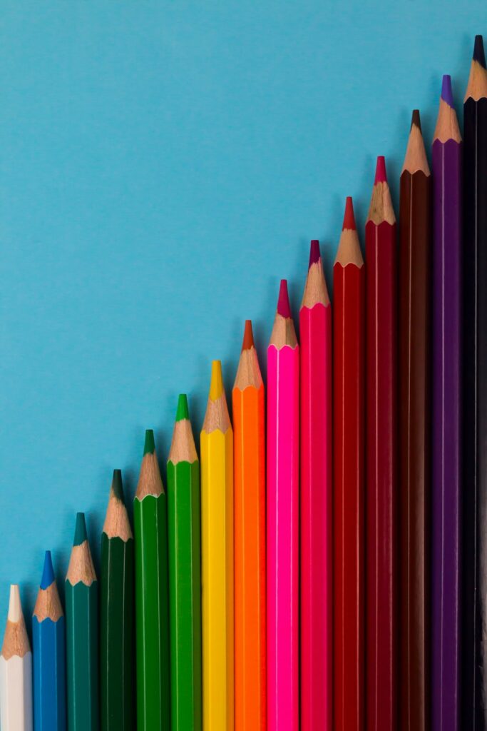 Color pencils isolated on blue paper background.